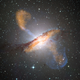 The Centaurus A galaxy, showing the characteristic jets of gas thrown off by a supermassive black hole. (Image: ESO/WFI (Optical); MPIfR/ESO/APEX/A.Weiss et al. (Submillimetre); NASA/CXC/CfA/R.Kraft et al. (X-ray))